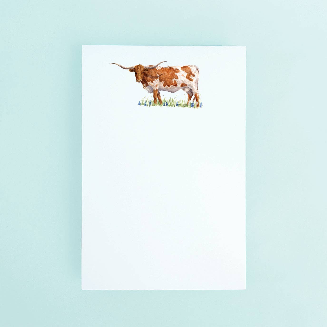 Taylor Paladino Standing Texas Longhorn in A field of Bluebonnets Notepad